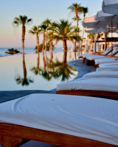 Luxury hotel by a pool in a tropical setting, showcasing website design for service-based businesses.