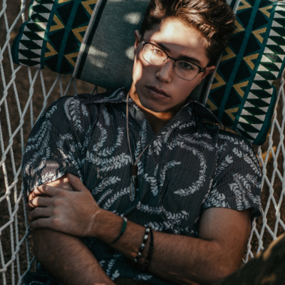 high school senior boy laying on hammock senior portrait