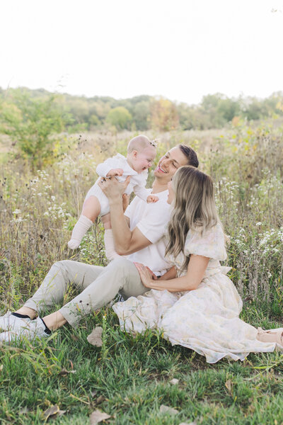 Beautiful family in a field with baby