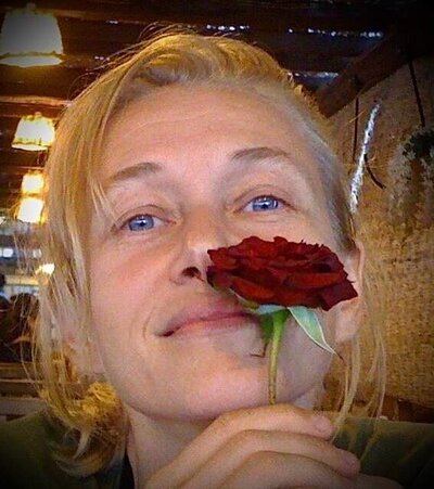 Blonde woman holding a rose