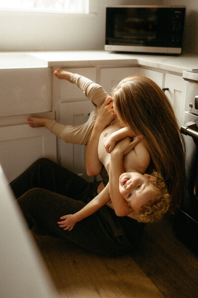 A husband holding his wife up in the air. 