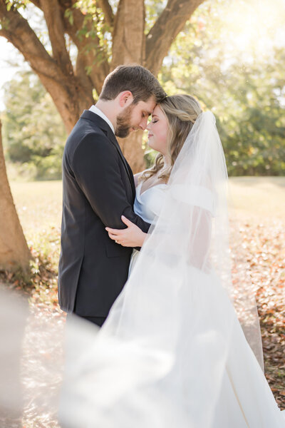 Beautiful couple embraces with a kiss for their wedding at the Ice House Venue in Jackson Mississippi.