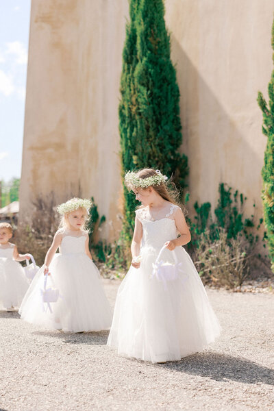 Flower girls walk down the aisle outside of Montaluce Winery and Restaurant