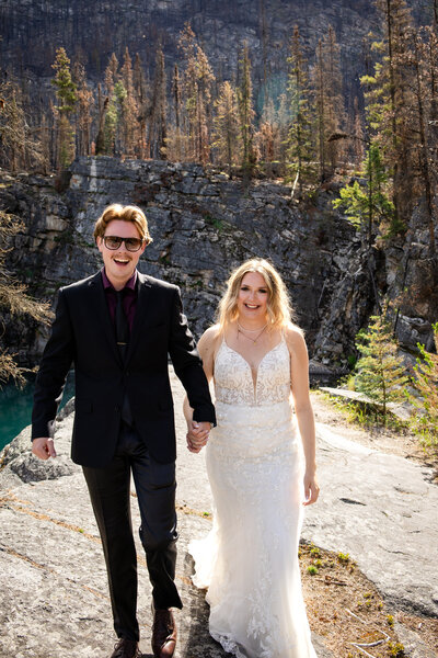 A happy couple in wedding attire along the Horseshoe Lake cliffs 