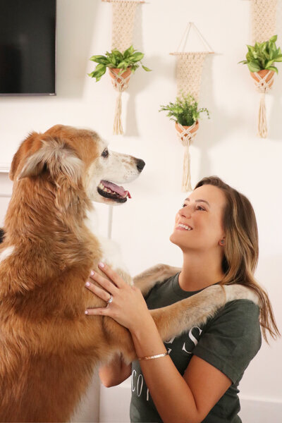 woman smiling at dog