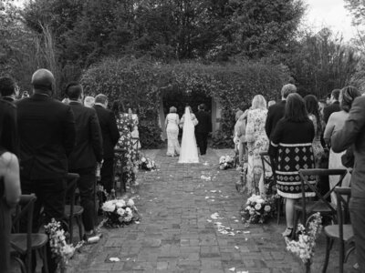 bride walking down ceremony aisle at Inola Blue Ridge