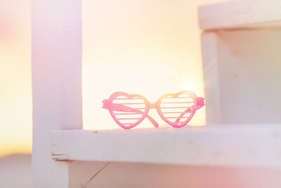 Pink glasses in front of sunset