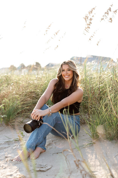 destination wedding photographer poses for camera during headshot.