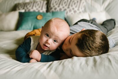 brothers laying on the bed