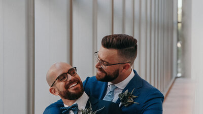 gay couple poses for wedding video