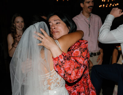 A person hugging a bride