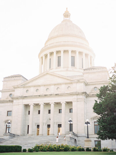 Family walks up the stairs at the entrance of the Arkansas State Capitol in Little Rock taken by photographer Bailey Feeler