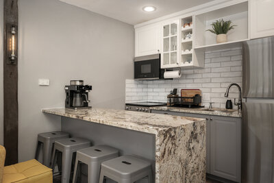 Clean modern kitchen with white cabinets and white backsplash