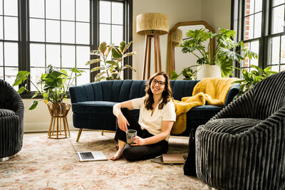 Melonie, the founder of Grassroots Creative Company, smiling at her workspace in Chardon, Ohio.