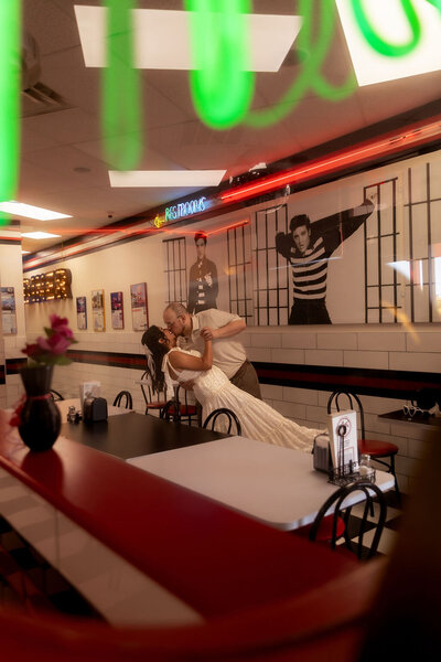 Couple dancing inside a classic diner during their Utah session, captured by Lamblight Photography