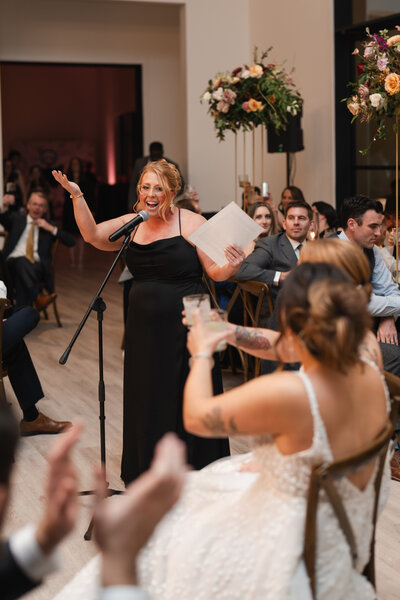 a maid of honor delivers a wedding speech at high-end luxury wedding