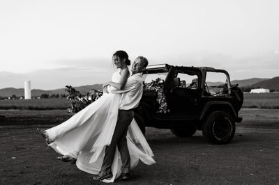 Bride and groom dancing in front of a Jeep taken by CDA wedding photographer.