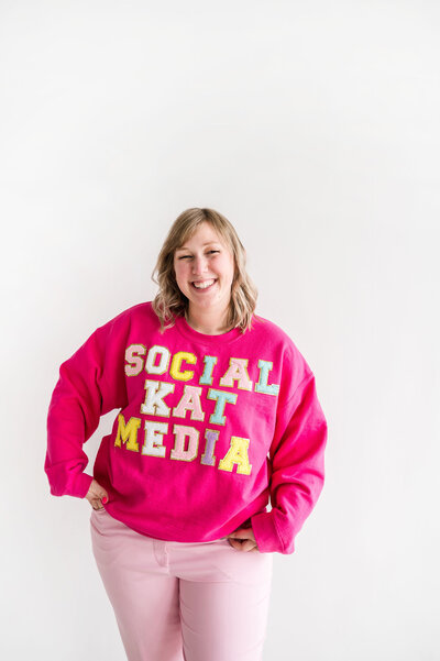 Kat Murphy in a pink Social Kat Murphy sweatshirt