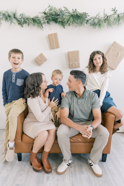Family sitting on couch for holiday photo session