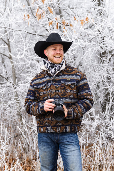 man smiling in the woods