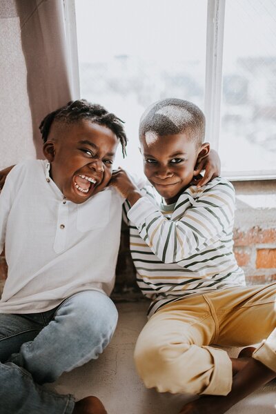 Theo and Uriah Henry tickling each other in Los Angeles, California.
