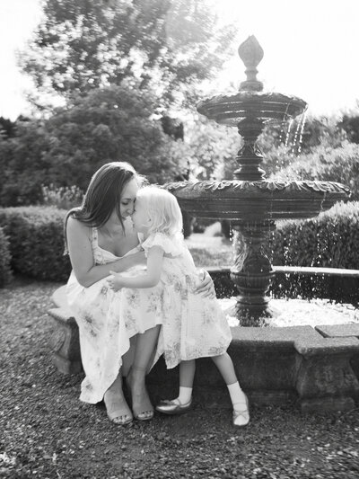 Mother and daughter cuddling on a sofa in a studio in Vancouver