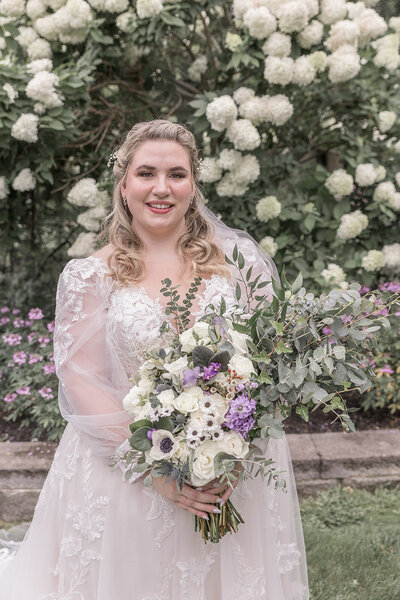 Detroit Michigan bride smiling with her bouquet in her arms