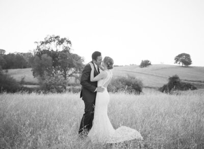 Couple kisses after a memorable ranch wedding in Oregon Wine County.