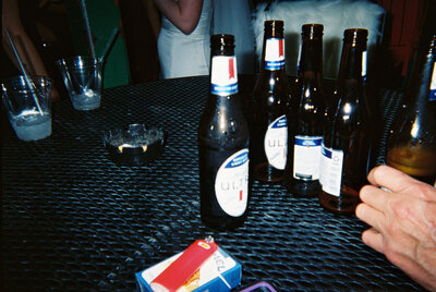 An indie LGBTQ+ couple’s moody editorial wedding portrait, photographed in a true-to-color style by Chelsea Stanford in Missouri.