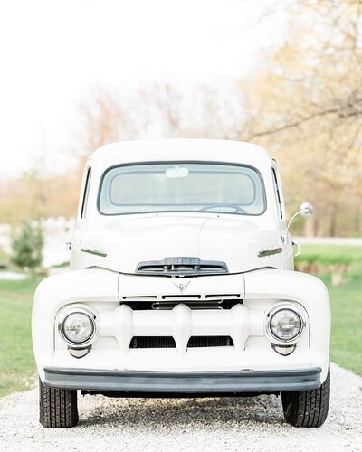 White 1951 Ford truck outdoors at Jennifer Hall Photography, LLC.