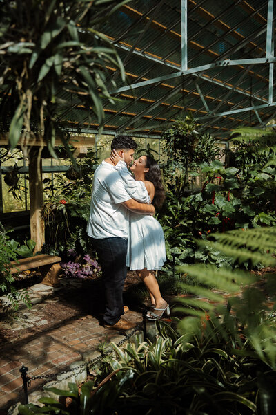 couple mini golfing for their engagement session on clearwater beach