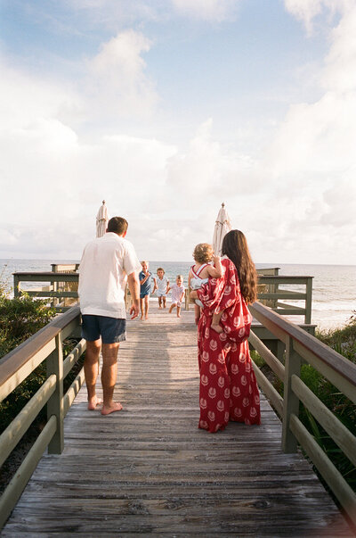 Bride surrounded by smiling bridesmaids in pink dresses