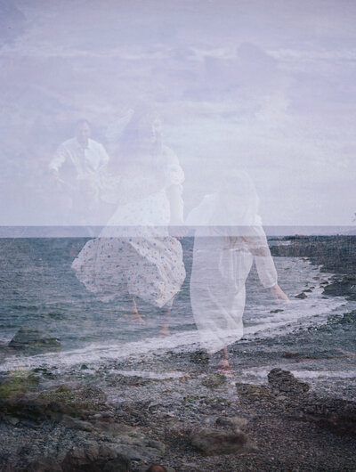 Photo of a family running on the beach with a double exposure of a rocky coastline by richmond va family photographer jacqueline aimee portraits