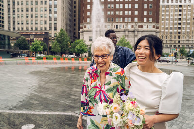 A couple sharing a laugh with another woman.