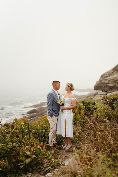 A couple taking wedding portraits at Two Lights in Cape Elizabeth Maine Photographed by Hattie Mae Photography