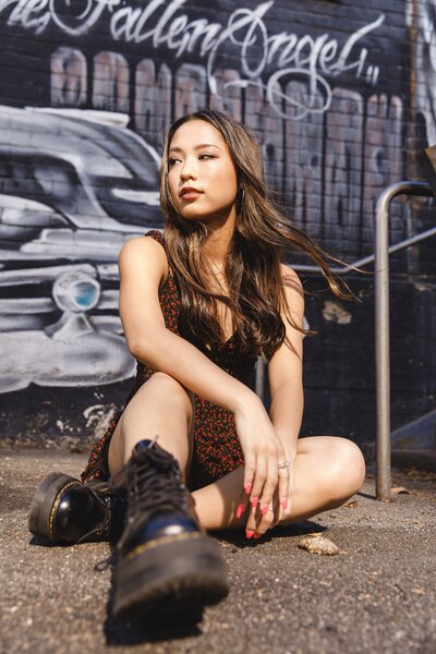 bold and dynamic portrait of a teen girl posing against graffiti wall in Los Angeles, California