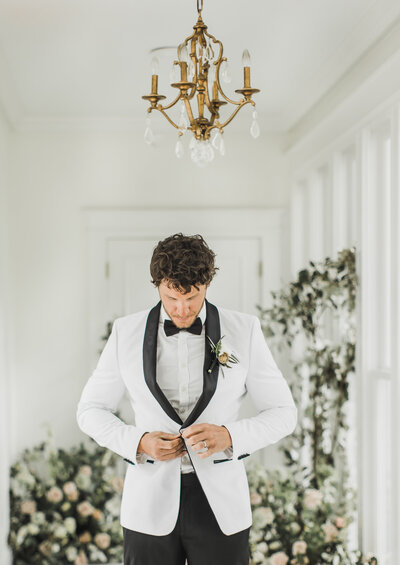 Wedding Photographer & Elopement Photographer, groom buttoning his jacket