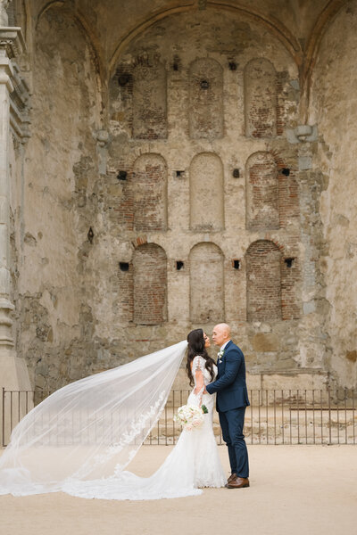 San Juan Capistrano Mission Wedding Romantic shot with a flowing veil