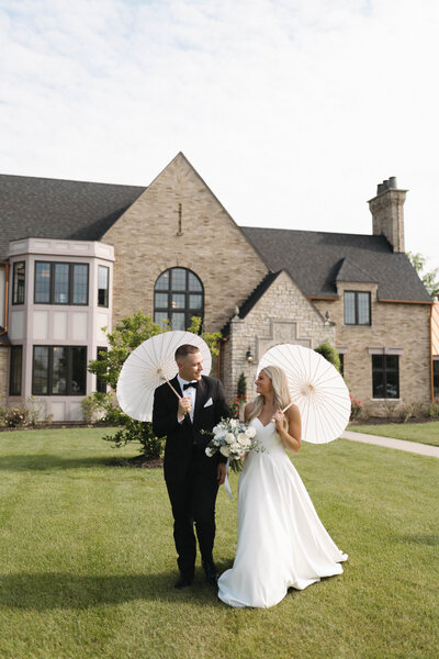 bride and groom portrait with parasols