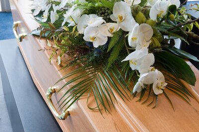 White flowers on wood casket