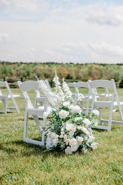 wedding details white chair and flowers