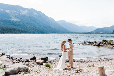 Bride reads her vows to her groom on the shores of Lake Wenatchee in Leavenworth