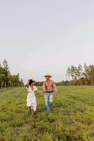 Frolicking through a field, while laughing together | engagements 