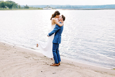 Bride and groom kissing at MADDEN'S RESORT ON GULL LAKE