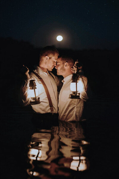 gay-elopement-couple-with-lanterns-in-lake-artistic-lgbtq