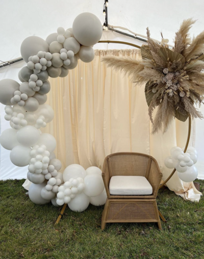 Stunning white balloon arch with pampas grass for a wedding or outdoor event.