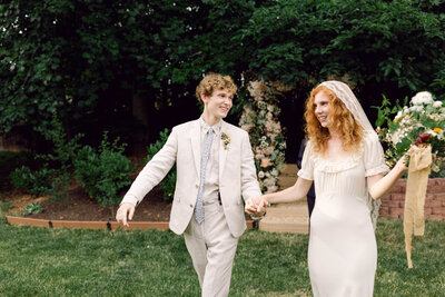 A candid, film-style photograph of bride Peyton Curry in a reflective moment during her backyard wedding in Richmond, Virginia.