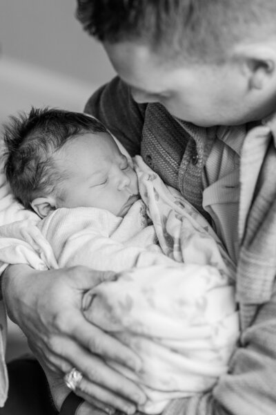 man-holding-newborn-baby-girl