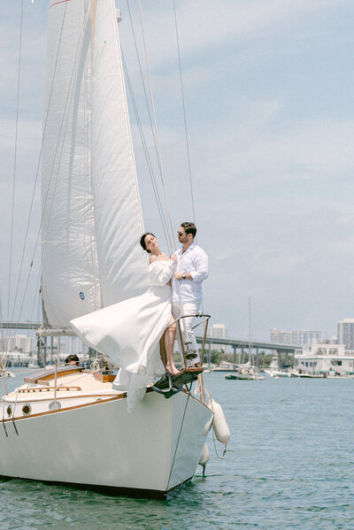 bride and groom sailboat  by Miami Elopement Photographer