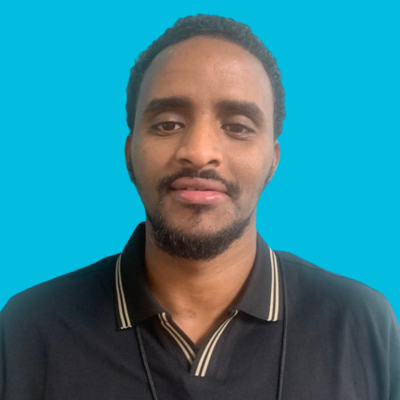 black man therapist at Move Forward with dark hair in white shirt and black suit jacket with blue backgorund